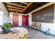Covered patio with seating and a red door entrance at 5984 W Augusta Ave, Glendale, AZ 85301