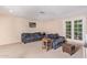 Spacious living room with dark gray couches and a wooden coffee table at 6208 W Karen Lee Ln, Glendale, AZ 85306