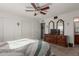 Bedroom with ceiling fan, dresser, and ensuite access at 6440 E Dallas St, Mesa, AZ 85205