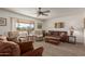 Living room with brown couches, two recliners, and a coffee table at 6440 E Dallas St, Mesa, AZ 85205