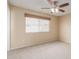Cozy bedroom with ceiling fan and neutral carpeting at 7202 W Carol Ave, Peoria, AZ 85345