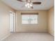 Bright bedroom with ceiling fan and neutral decor at 7202 W Carol Ave, Peoria, AZ 85345