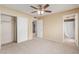Spacious bedroom with ceiling fan, large closet, and carpet at 7202 W Carol Ave, Peoria, AZ 85345