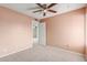 Bright bedroom with ceiling fan and carpet flooring at 7202 W Carol Ave, Peoria, AZ 85345