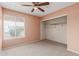 Simple bedroom with ceiling fan and ample closet space at 7202 W Carol Ave, Peoria, AZ 85345