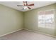 Spacious bedroom with ceiling fan and large window at 7202 W Carol Ave, Peoria, AZ 85345