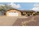 House exterior features a tan facade, solar panels, and a landscaped front yard at 7202 W Carol Ave, Peoria, AZ 85345