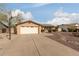 Exterior view showcases a tan house with a two-car garage and basketball hoop at 7202 W Carol Ave, Peoria, AZ 85345