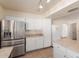 Modern kitchen features stainless steel refrigerator and white cabinets at 7202 W Carol Ave, Peoria, AZ 85345