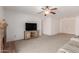 Living room with brick fireplace, neutral carpet, and double doors at 7202 W Carol Ave, Peoria, AZ 85345