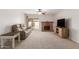 Living room boasts a brick fireplace, sliding glass door, and neutral carpet at 7202 W Carol Ave, Peoria, AZ 85345