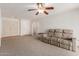 Living room features neutral carpeting, ceiling fan, and a large window at 7202 W Carol Ave, Peoria, AZ 85345