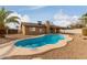 Kidney shaped swimming pool in backyard with tan colored decking at 7202 W Carol Ave, Peoria, AZ 85345