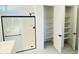 Bright bathroom with glass shower, storage shelving and modern fixtures at 7802 E Quintana Ave, Mesa, AZ 85212