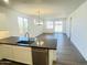Bright living area with hardwood floors, stainless steel appliances, and sliding glass doors to the backyard at 7802 E Quintana Ave, Mesa, AZ 85212