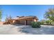 Three-car garage with brown doors and a brick exterior at 8280 S Pecan Grove Cir, Tempe, AZ 85284