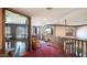 Upper hallway with red carpet, arched windows, and a pool table at 8280 S Pecan Grove Cir, Tempe, AZ 85284
