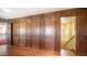 Elegant hallway with wood paneling, hardwood floors, and a staircase at 8280 S Pecan Grove Cir, Tempe, AZ 85284