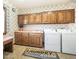 Laundry room with washer, dryer, cabinets, and countertop space at 8280 S Pecan Grove Cir, Tempe, AZ 85284