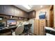 Home office with a computer desk, filing cabinets, and printer at 8280 S Pecan Grove Cir, Tempe, AZ 85284