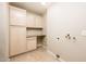 Laundry room with light wood cabinets and countertop at 8709 W Monroe St, Peoria, AZ 85345