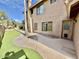 Landscaped backyard with putting green and access to home at 938 W Iris Dr, Gilbert, AZ 85233