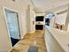 Light-filled hallway with wood floors and access to bedrooms at 938 W Iris Dr, Gilbert, AZ 85233