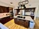 Island kitchen with stainless steel appliances and dark wood cabinets at 938 W Iris Dr, Gilbert, AZ 85233
