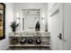 Modern bathroom boasts a marble vanity with a vessel sink and built-in shelving at 10163 E Hualapai Dr # 2917, Scottsdale, AZ 85255