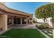 Artificial turf lawn, covered patio, and mature shrubbery at 10473 N 87Th Pl, Scottsdale, AZ 85258