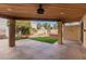 Covered patio area with artificial turf and manicured landscaping at 10473 N 87Th Pl, Scottsdale, AZ 85258