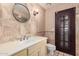 Bathroom with single sink vanity, toilet, and decorative tile at 10473 N 87Th Pl, Scottsdale, AZ 85258