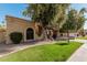 Tan stucco house with brown gate and nicely landscaped yard at 10473 N 87Th Pl, Scottsdale, AZ 85258