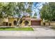 Spanish style home with landscaped yard and two-car garage at 10473 N 87Th Pl, Scottsdale, AZ 85258