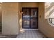 Black metal front door with geometric glass panes at 10473 N 87Th Pl, Scottsdale, AZ 85258