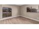 Well-lit room featuring wood-look tile floors and large windows at 10473 N 87Th Pl, Scottsdale, AZ 85258