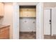 Laundry closet with built-in cabinets and tile flooring at 10473 N 87Th Pl, Scottsdale, AZ 85258