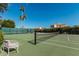 Community tennis court with a bench and surrounding landscape at 10473 N 87Th Pl, Scottsdale, AZ 85258