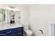 Updated bathroom with navy vanity, white countertop, and modern fixtures at 10529 W Palmeras Dr, Sun City, AZ 85373