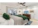 Main bedroom with green velvet comforter and views to the dining area at 10529 W Palmeras Dr, Sun City, AZ 85373