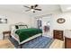 Main bedroom with green velvet comforter and access to the dining area at 10529 W Palmeras Dr, Sun City, AZ 85373