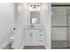 Modern bathroom with white vanity, marble shower, and black accents at 10662 S 297Th Ave, Palo Verde, AZ 85343