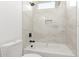 Clean bathroom with shower/tub combo and marble tile at 10662 S 297Th Ave, Palo Verde, AZ 85343