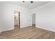 Bright bedroom with wood-look floors and ensuite bathroom access at 10662 S 297Th Ave, Palo Verde, AZ 85343