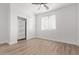 Spacious bedroom featuring wood-look floors and built-in shelving at 10662 S 297Th Ave, Palo Verde, AZ 85343