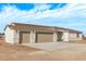 New single-story home with three-car garage and desert landscaping at 10662 S 297Th Ave, Palo Verde, AZ 85343