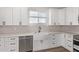 Kitchen features white cabinets, farmhouse sink, and stainless steel appliances at 10662 S 297Th Ave, Palo Verde, AZ 85343