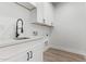 Bright laundry room with white cabinets and a modern sink at 10662 S 297Th Ave, Palo Verde, AZ 85343