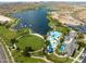 Aerial view of lake, community pool, and surrounding green areas at 10724 S Mustang Dr, Goodyear, AZ 85338