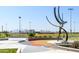 Landscaped baseball field with modern art sculpture in the foreground at 10724 S Mustang Dr, Goodyear, AZ 85338